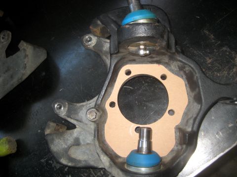 1996 Ford Bronco - Close-up of a vehicle's front suspension knuckle and ball joint assembly.