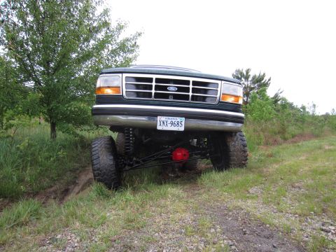 1992 Ford Bronco - This lifted 1992 Ford Bronco is shown from the front, with its suspension and large tires clearly visible.