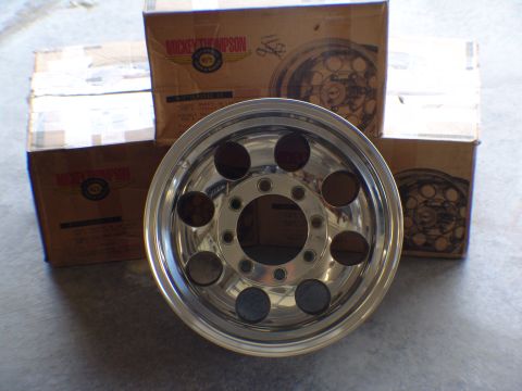 1996 Ford Bronco - A single chrome wheel is displayed in front of several cardboard boxes with the Mickey Thompson logo.