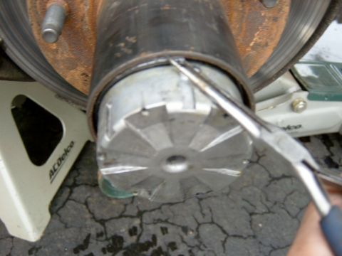 1995 Ford Bronco - I found that a very small pair of needle nose pliers works the best for this, just because you can grab it if it tries to slip back in.