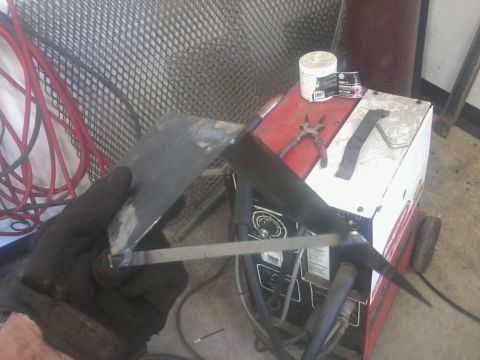 1995 Ford F-150 - A dual battery tray with isolator is shown, with welding equipment and tools in the background.