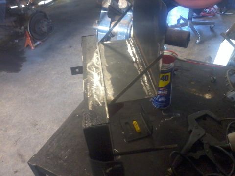 1995 Ford F-150 - A custom-welded dual battery tray and isolator mount is shown in a workshop setting.