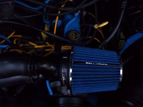 1989 Ford Bronco - Close-up of a blue Spectre cold air intake filter installed in an engine bay.