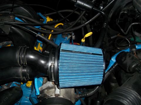 1989 Ford Bronco - Close-up of a blue cone air filter in an engine bay, likely an aftermarket upgrade.
