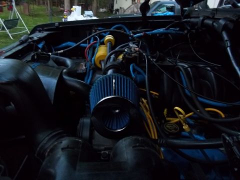 1989 Ford Bronco - Engine bay details showing a cold air intake system with blue hoses and filter.