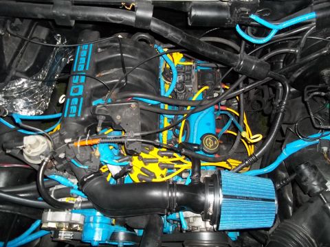 1989 Ford Bronco - Engine bay modifications with custom blue and yellow wiring and a blue air filter are visible.