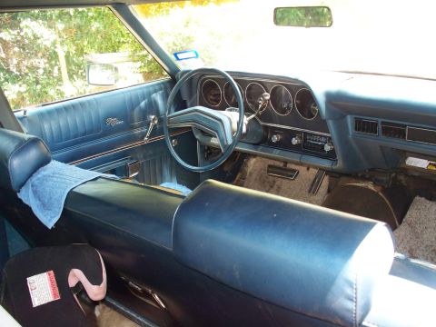 1976 Ford Torino - The interior of a 1976 Ford Torino features blue upholstery and a classic dashboard layout.