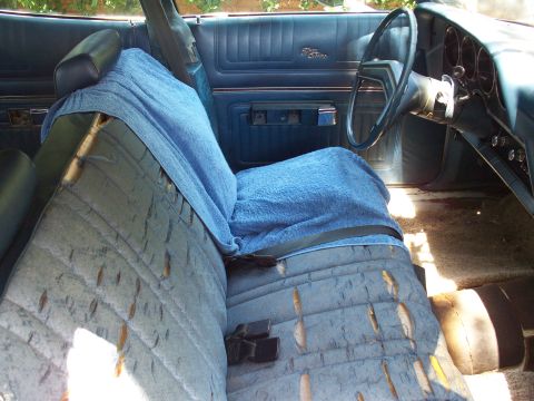 1976 Ford Torino - Interior view of a 1976 Ford Torino, highlighting worn upholstery and dashboard details.