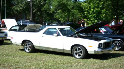 1976 Ford Ranchero - A white Ford Ranchero is displayed with its hoods open at an outdoor car show.