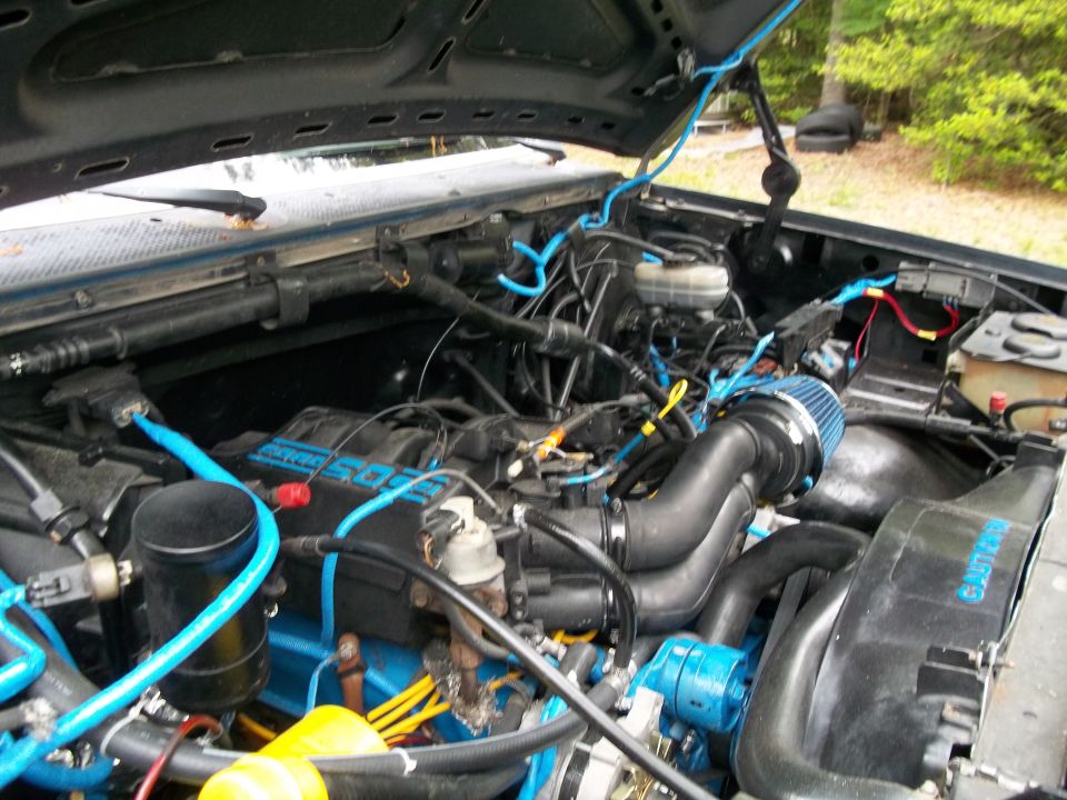 Engine bay with blue hoses and aftermarket air filter