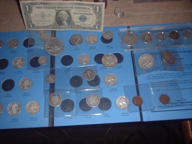 Coin collection with a dollar bill on a blue display board