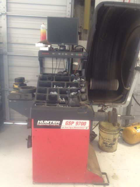 2000 Jeep Wrangler - Hunter GSP 9700 wheel balancer machine shown in a garage setting.