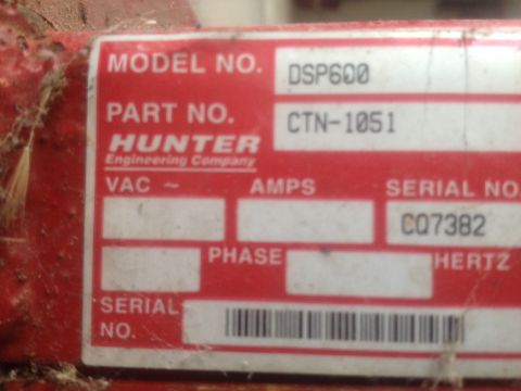 2000 Jeep Wrangler - A close-up of a red metal object shows a white label with technical specifications from Hunter Engineering Company.