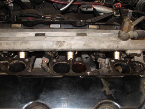 1992 Ford Taurus - Close-up view of an engine's intake manifold, showing fuel injectors and associated wiring.
