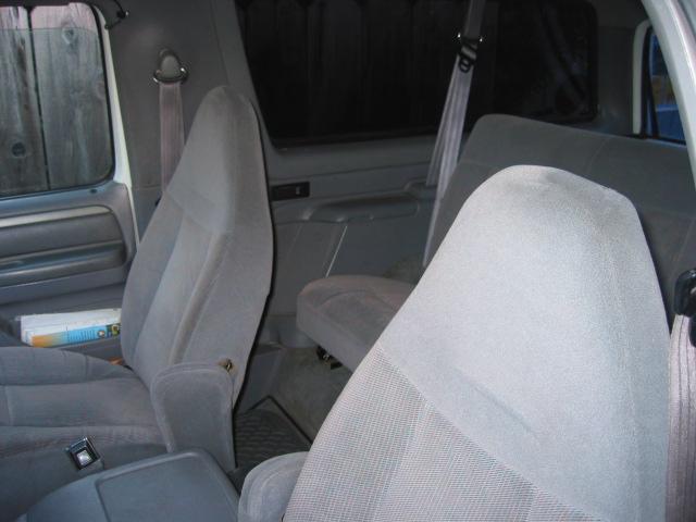 Gray interior of a 1995 Ford Bronco, showing front and rear seats