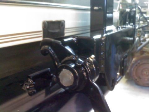 1996 Ford Bronco - Close-up of a black suspension component with a silver bolt head visible.