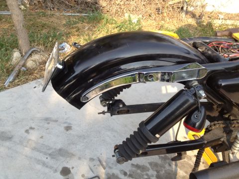1995 Ford Bronco - Close-up of a motorcycle's rear fender and suspension system with visible wiring.