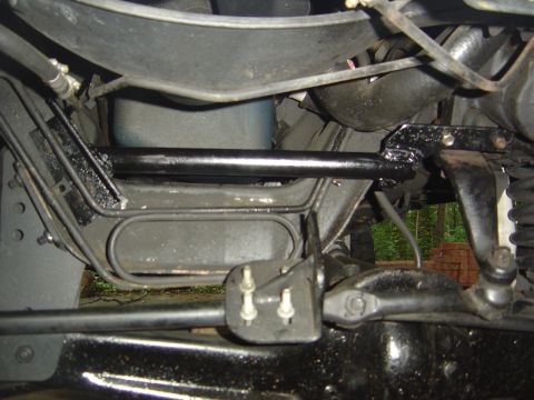 1986 Ford Bronco - Close-up view of the steering box bracket and associated linkage components.