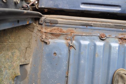 1986 Ford Bronco - Close-up view of a corroded interior panel, showing signs of wear and tear.