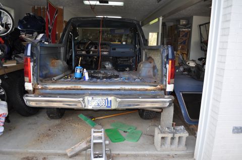1986 Ford Bronco - The interior of this Ford Bronco is being worked on, with tools and equipment scattered inside the cabin and bed.