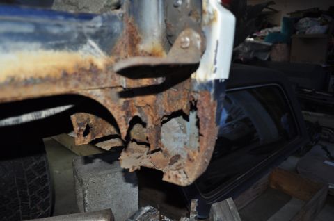 1986 Ford Bronco - The vehicle's frame is severely corroded, indicating extensive rust damage.