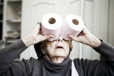 1987 Ford Bronco - An elderly woman uses toilet paper rolls as makeshift binoculars, looking intently at something out of frame.