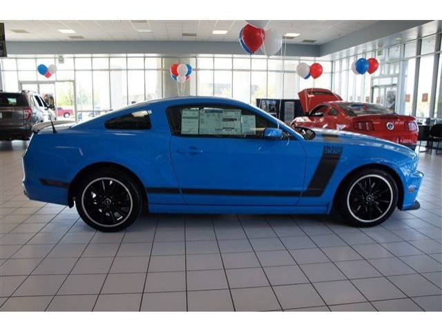 Blue 2013 Ford Mustang Boss 302 side view with black racing stripes
