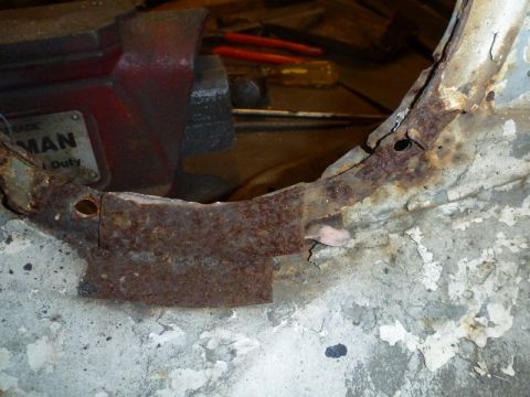 1969 MINI Cooper - Close-up of a heavily rusted car body panel, showing signs of wear and tear.