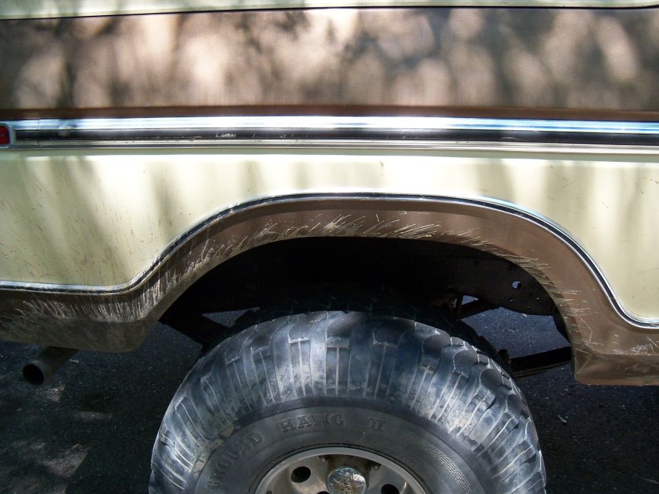 1979 Ford Bronco rear wheel well with chrome trim and two-tone paint