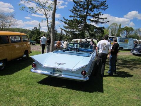 1991 Ford LTD Crown Victoria - A light blue convertible with distinctive fins is parked on a grassy field at an outdoor event.