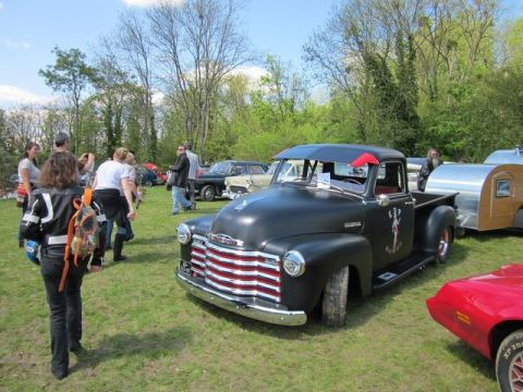 1991 Ford LTD Crown Victoria - A classic black Chevrolet pickup truck, likely from the early 1950s, is displayed at an outdoor car show with a small trailer attached.