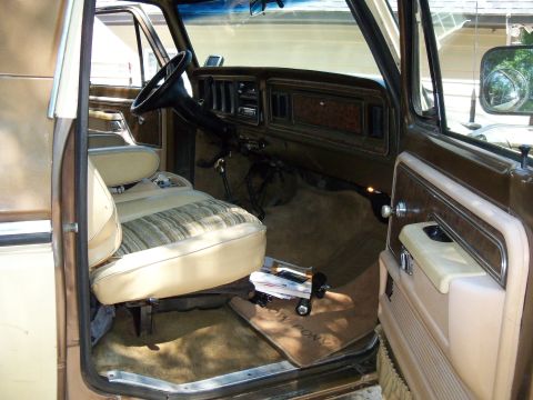 1979 Ford Bronco - Interior of a 1978 Ford Bronco, cloth seats and woodgrain accents on the dashboard and door.