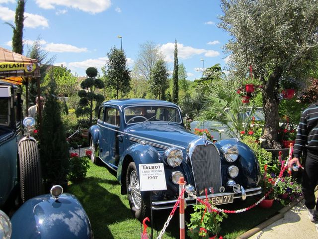 Blue Talbot Lago Record sedan with a sign indicating 1947, parked outdoors on grass