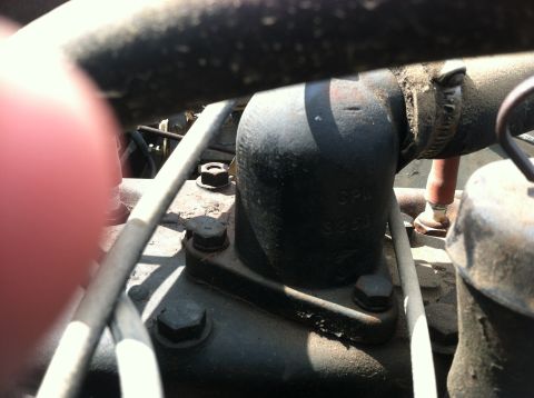 1986 Ford Bronco - A close-up view of an engine component shows stamped casting numbers, suggesting it is a specific part rather than a complete vehicle.