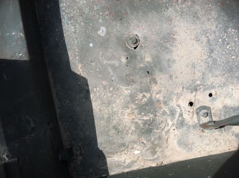 1986 Ford Bronco - Close-up view of the vehicle's underbody, showing signs of wear and tear.