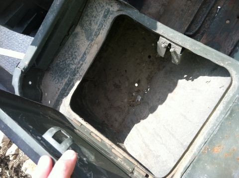 1986 Ford Bronco - Interior view of a vehicle's storage compartment, revealing its condition.