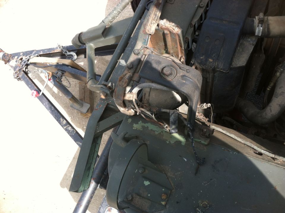 Close-up of a vehicle's engine bay and part of a trailer hitch assembly