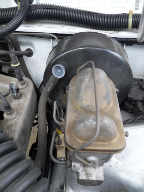 1994 Jeep Cherokee - Engine bay view of brake booster and master cylinder components.