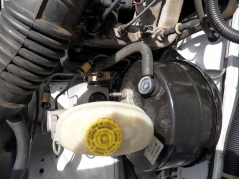 1994 Jeep Cherokee - Close-up view of the brake booster and master cylinder assembly under the hood.