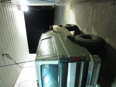 1992 Ford Bronco - This vehicle is on its side, showing damage to the roof and tires.