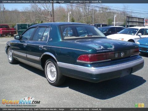 1994 Mercury Grand Marquis - 1994 Mercury Grand Marquis LS in dark green with beige trim, seen from the rear 3/4 angle.