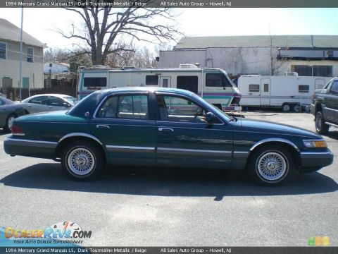 1994 Mercury Grand Marquis - Side profile of a 1994 Mercury Grand Marquis LS in dark green, parked near RVs.