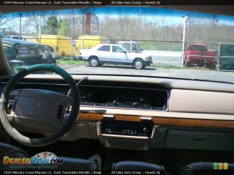 1994 Mercury Grand Marquis - View from inside a 1994 Mercury Grand Marquis, showing the dashboard and a white sedan in the background.