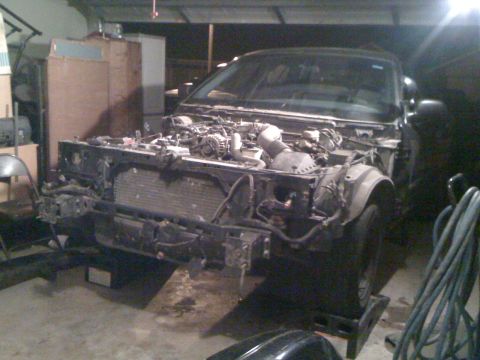 1994 Mercury Grand Marquis - Front end of a 1994 Mercury Grand Marquis disassembled for work in a garage.