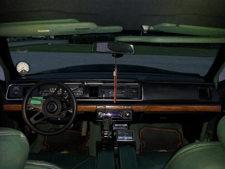 temperary self made consol. planning in making one out wood and fiber glass and painted black. grant steering wheel nice touch fron stock. white faces tach to know what im turning out. plan on making a custom white faced guage cluster to match the tach and also to replace that old style one. also have a different head unit than this one. 7 inch touch screen now