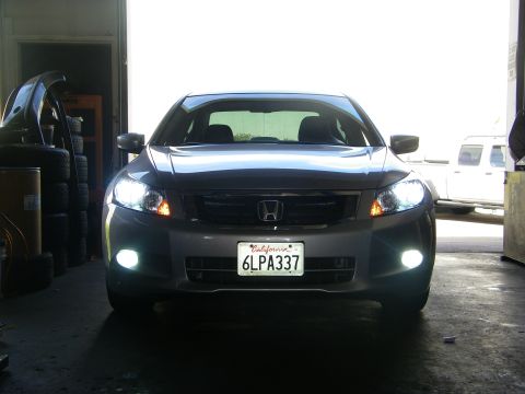 2010 Honda Accord - The front view of a silver Honda Accord sedan shows its headlights and fog lights illuminated.