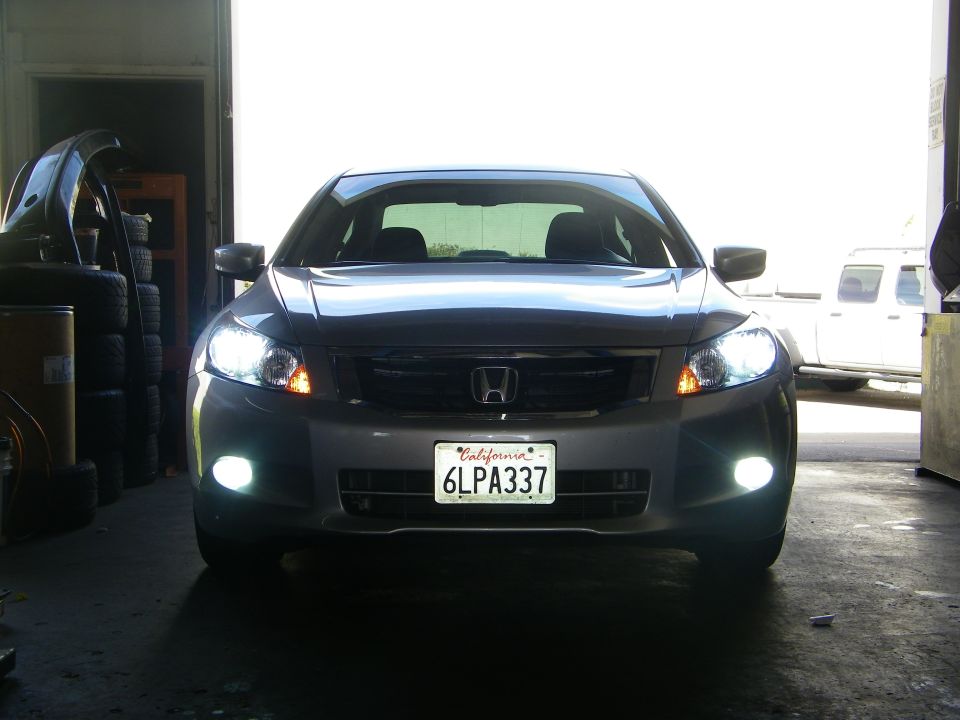 Silver Honda Accord sedan, front view, with California license plate 6LPA337. Headlights and fog lights are on