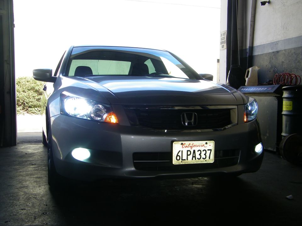 Front view of a gray 2010 Honda Accord with headlights and fog lights on