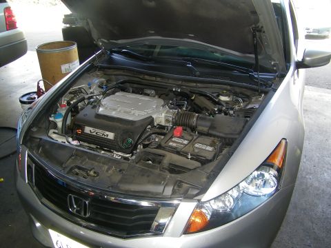 2010 Honda Accord - Front view of a silver Honda Accord with the hood open, showing the engine bay and VCM system.
