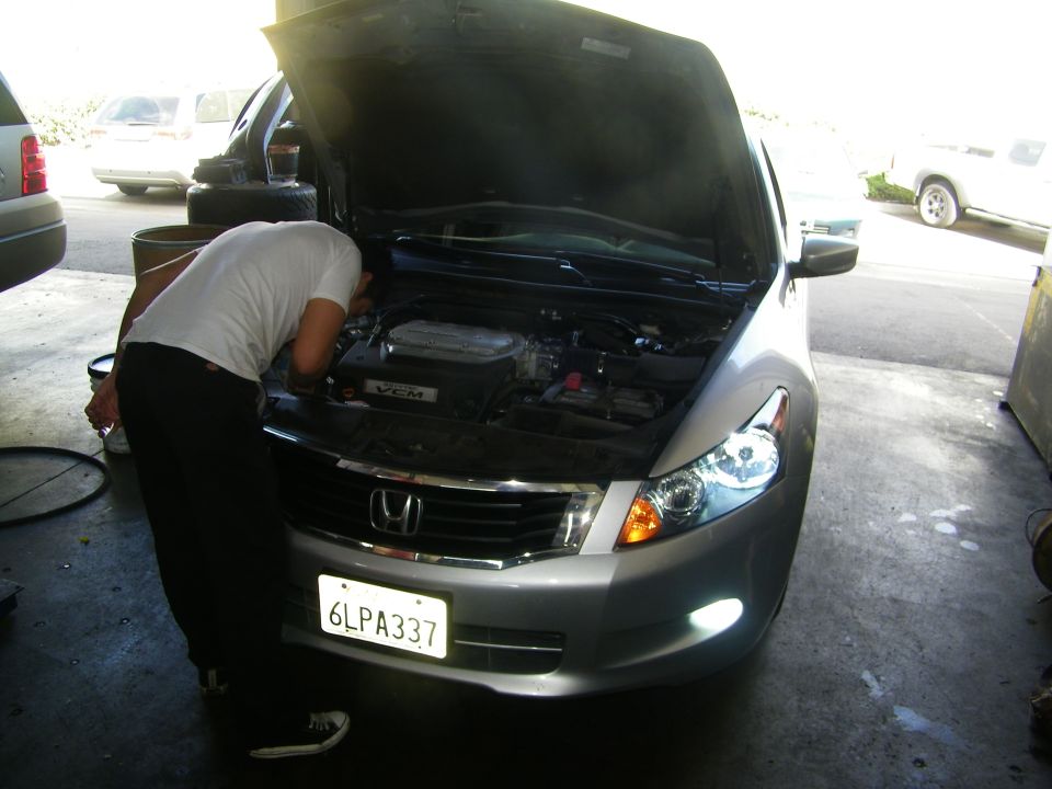 Silver Honda Accord with hood open, person looking at engine. License plate 6LPA337